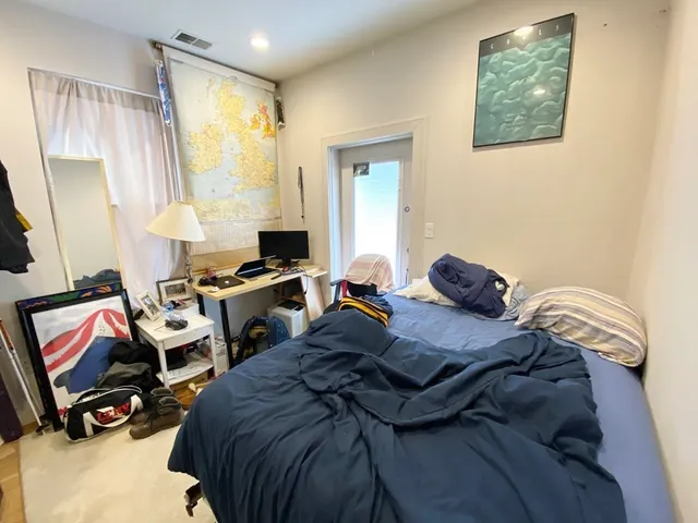 a bedroom with a bed and a window