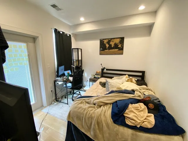 a bedroom with a bed and a mirror