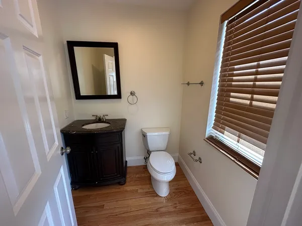 a view of a hallway with wooden floor and stairs