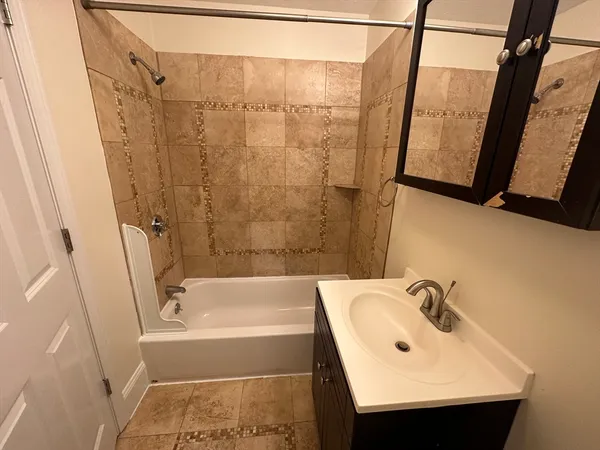 a bathroom with a sink a toilet and bathtub