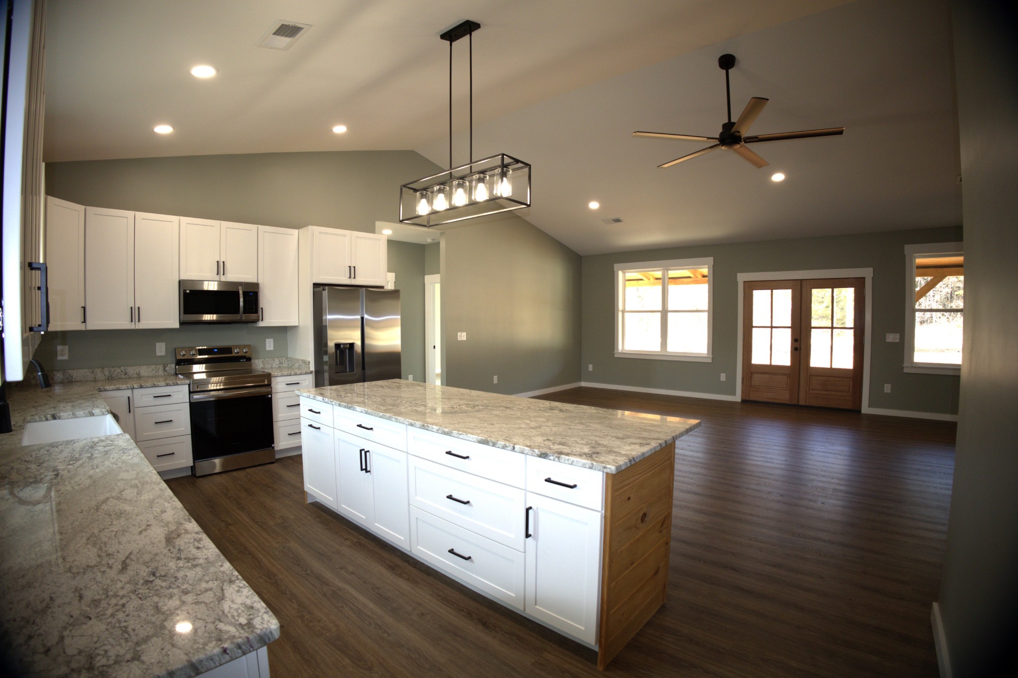 695 Woodland Road Hohenwald, TN 38462 - Photo 1 of 22 a kitchen with stainless steel appliances granite countertop a stove oven and a kitchen island