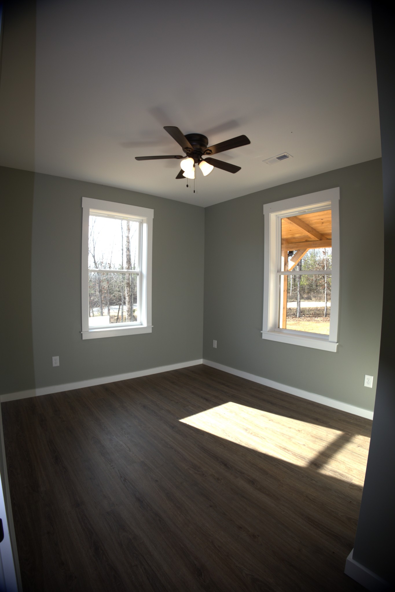 695 Woodland Road Hohenwald, TN 38462 - Photo 11 of 22 a view of an empty room with wooden floor and a window