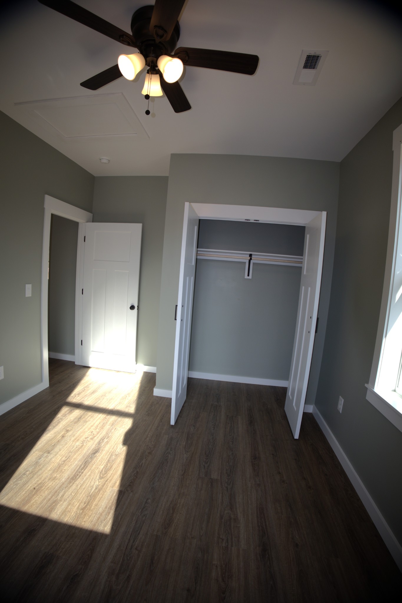 695 Woodland Road Hohenwald, TN 38462 - Photo 13 of 22 wooden floor in an empty room with a window