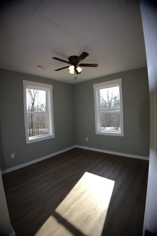 a room with a sink cabinets and wooden floor