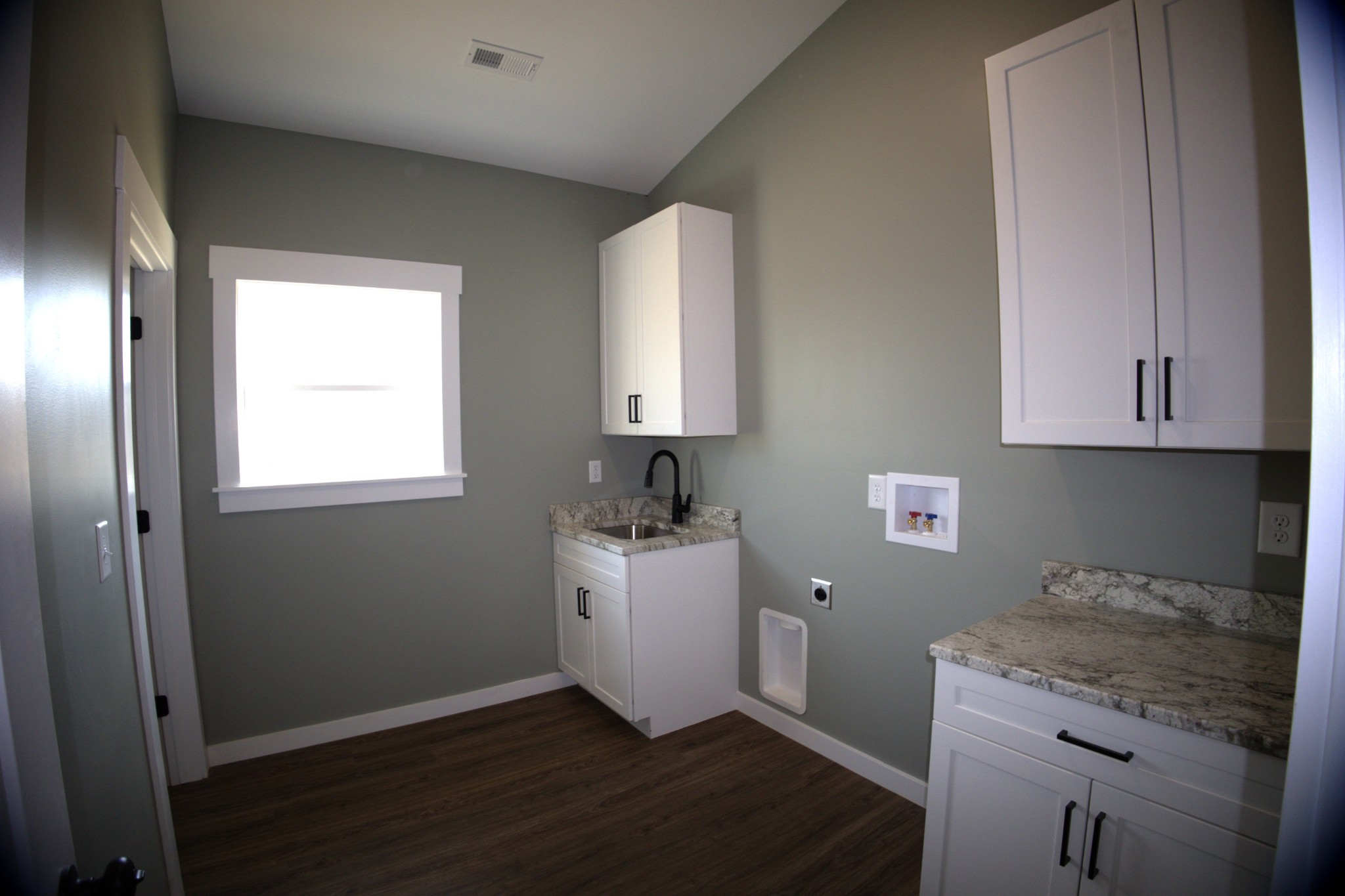 695 Woodland Road Hohenwald, TN 38462 - Photo 15 of 22 a room with a sink and cabinets