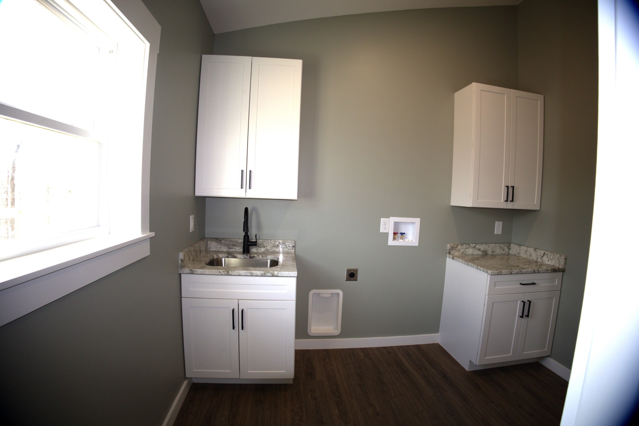 695 Woodland Road Hohenwald, TN 38462 - Photo 16 of 22 a room with a sink cabinets and wooden floor