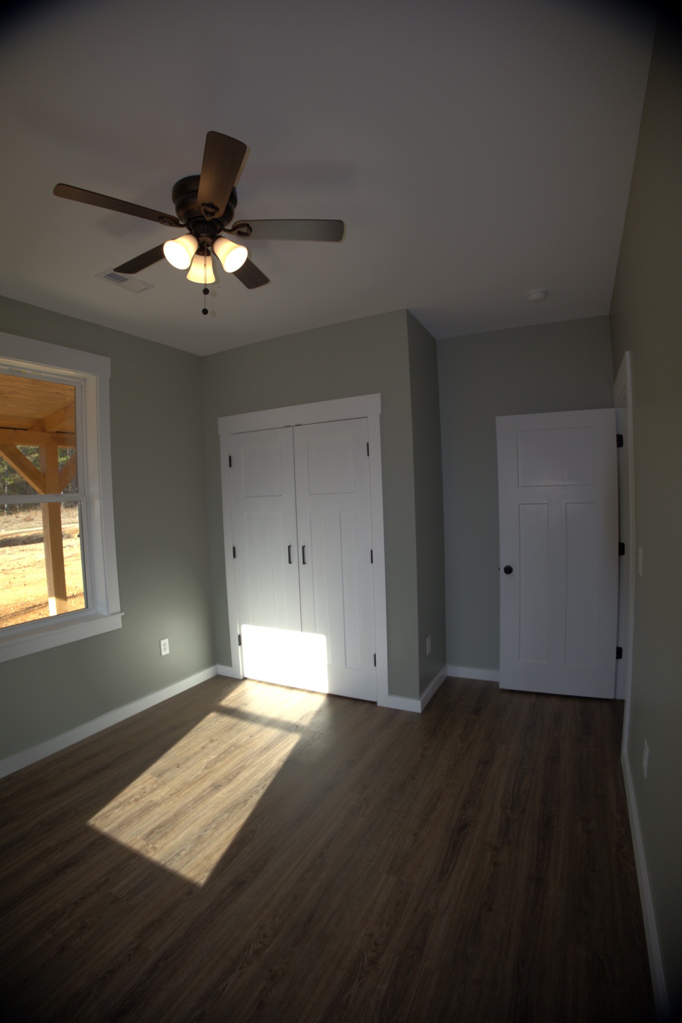 695 Woodland Road Hohenwald, TN 38462 - Photo 9 of 22 a view of empty room with wooden floor and fan