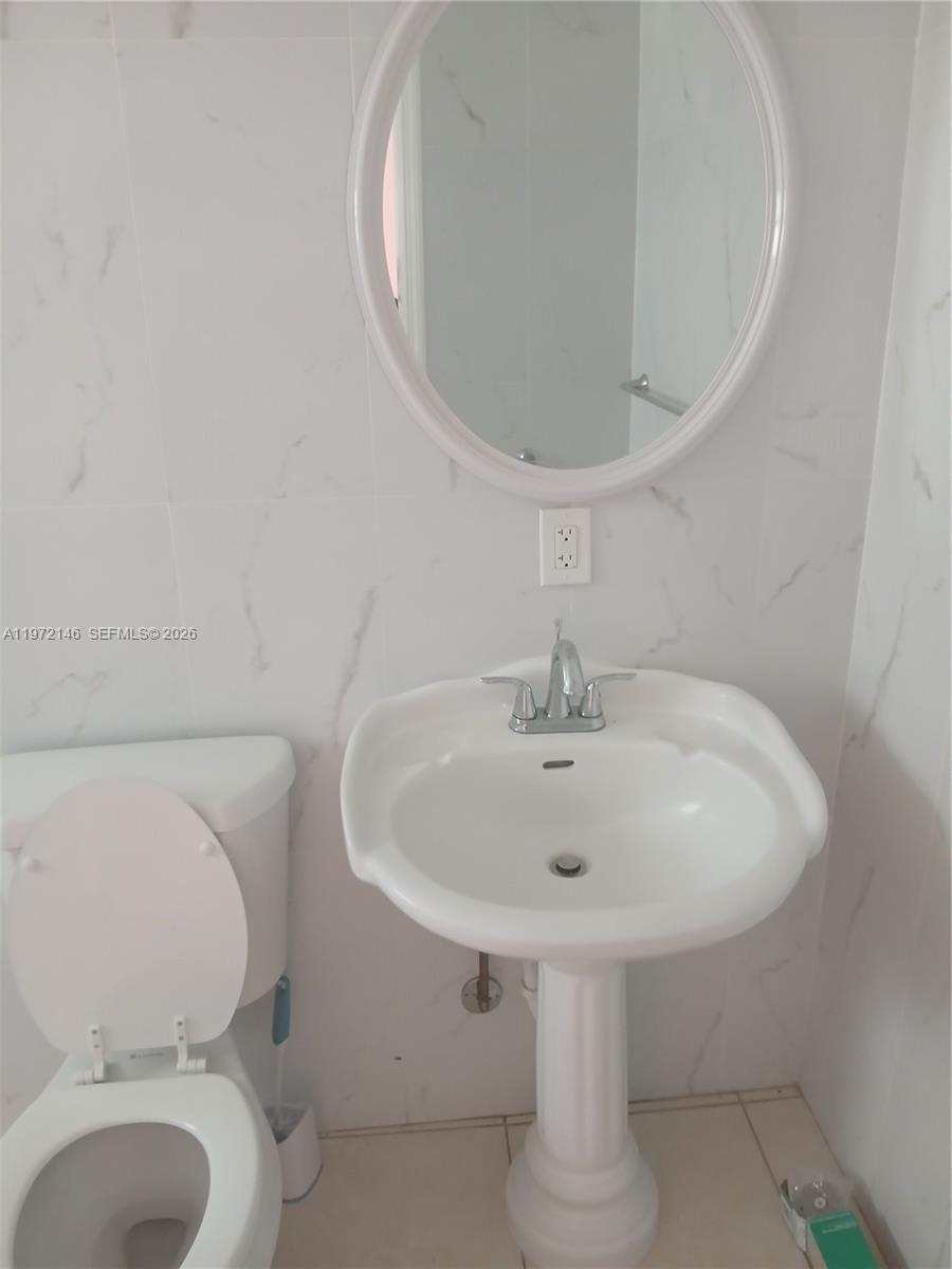 6471 Southwest 27th Street, Unit 2 Miramar, FL 33023 - Photo 23 of 41 a bathroom with a sink and a mirror