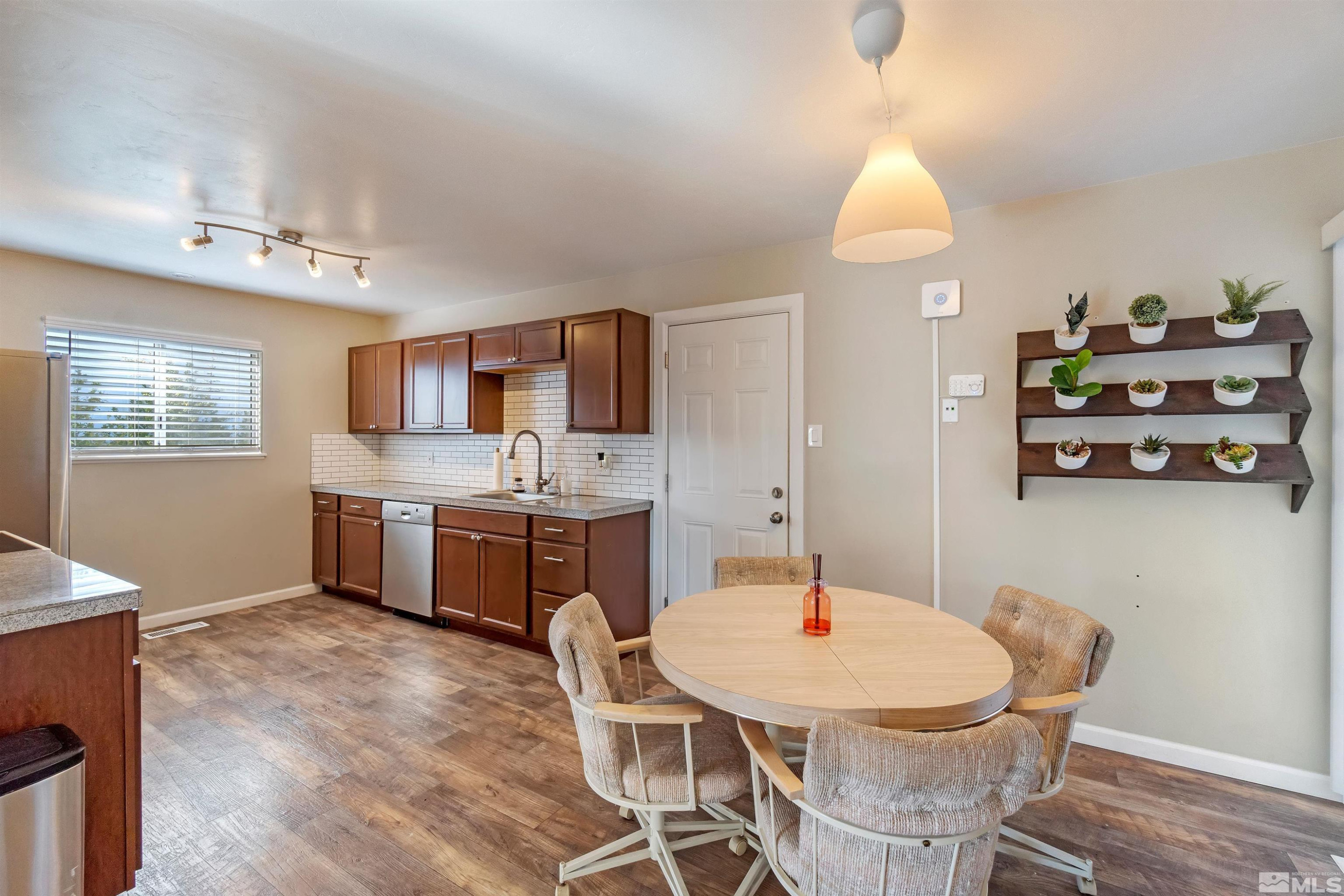 2960 Slater Avenue Reno, NV 89503 - Photo 13 of 30 a living room with stainless steel appliances kitchen island granite countertop a sink dishwasher and a stove with wooden floor