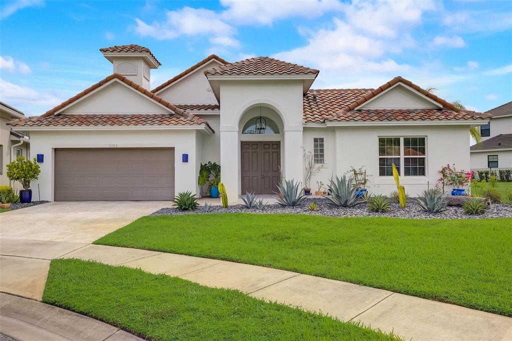 2123 Sherbrook Avenue Davenport, FL 33837 - Photo 1 of 56 a front view of a house with a garden and yard