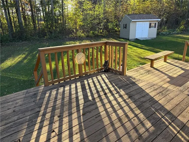 a view of balcony with wooden floor and lake view