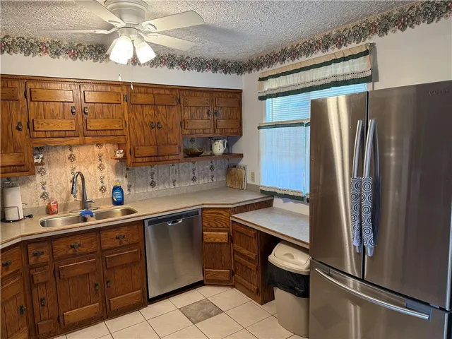 a kitchen with a sink appliances and cabinets
