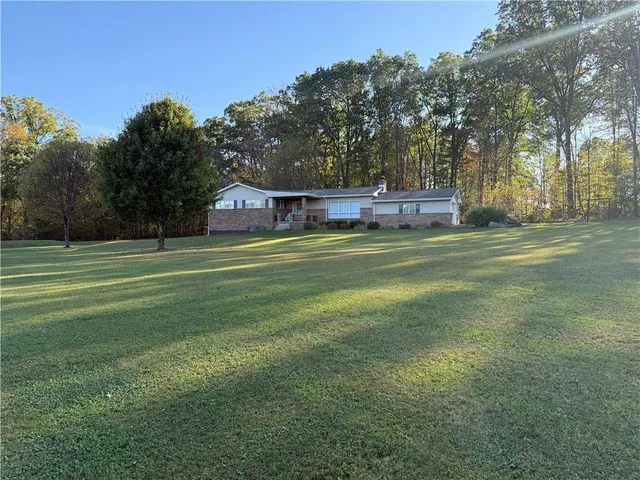 a front view of a house with a big yard