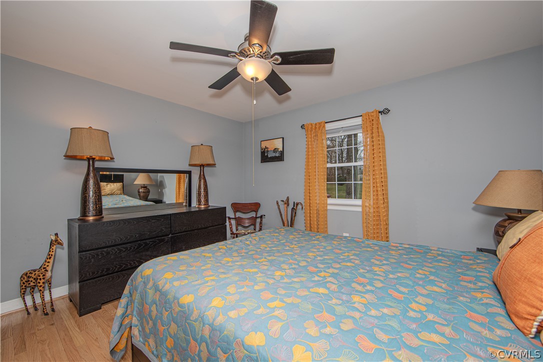 3601 Kiefer Road Chester, VA 23831 - Photo 23 of 46 a bedroom with a bed and a chandelier