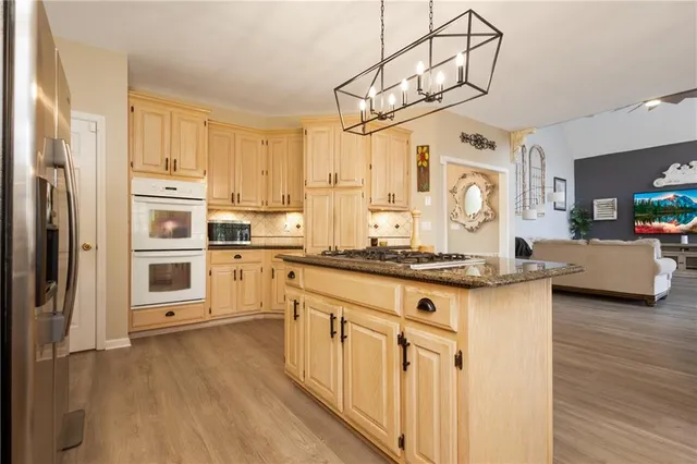 a kitchen with stainless steel appliances a white cabinets and a granite counter tops