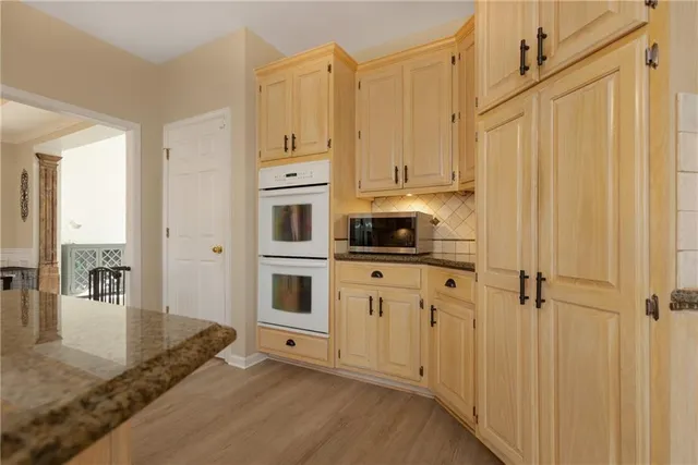 a large kitchen with a lot of counter space and stainless steel appliances