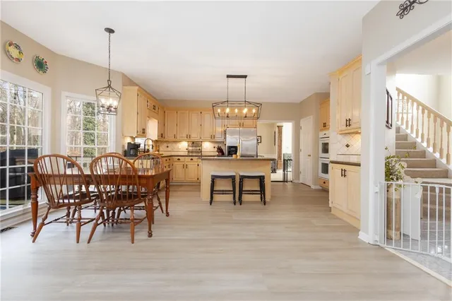 a living room with furniture a bed and a chandelier