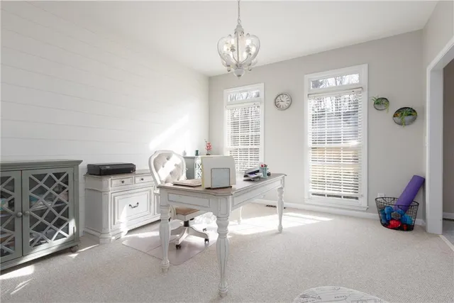 a spacious bedroom with a bed and a table with chair