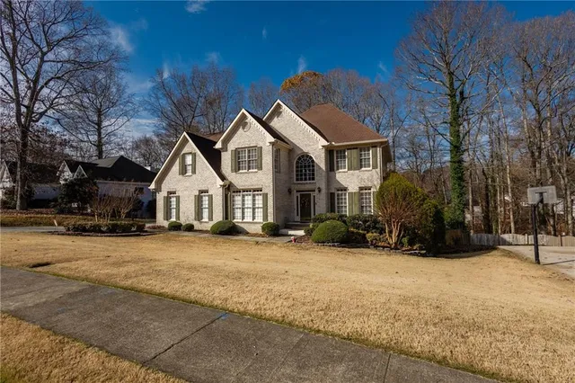 a view of a house with a yard covered in snow