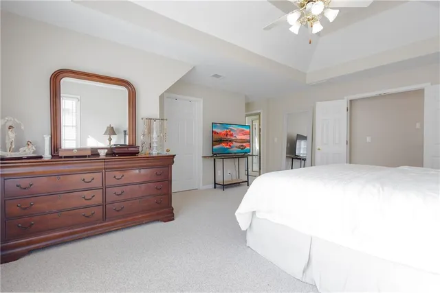 a bathroom with a granite countertop sink a mirror and a shower