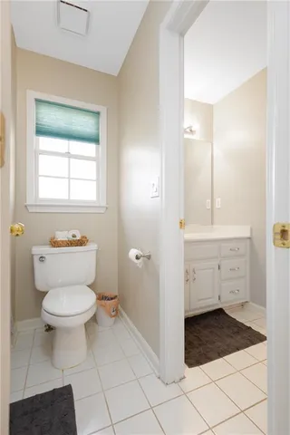 a living room with furniture a rug and a flat screen tv