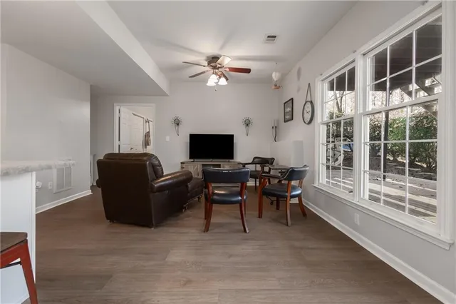 a view of a patio with couches chairs and wooden floor