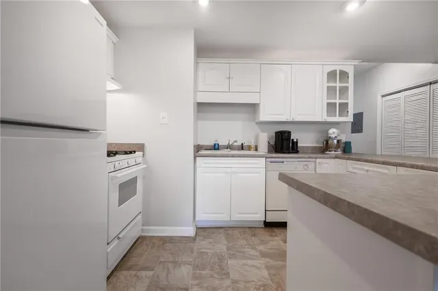 a view of a pathway of a house with wooden floor next to a road