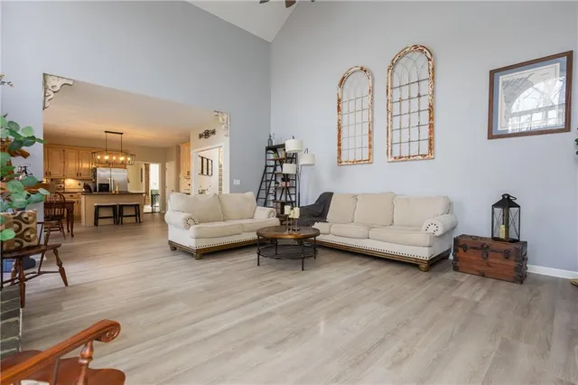 a kitchen with stainless steel appliances granite countertop a table chairs sink and cabinets