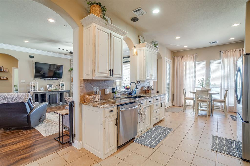 9409 County Road 915 Godley, TX 76044 - Photo 13 of 40 a kitchen with stainless steel appliances a stove a sink a refrigerator and cabinets
