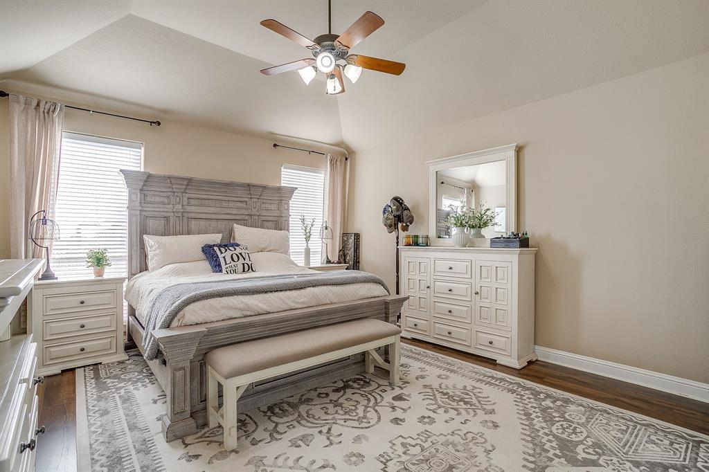 9409 County Road 915 Godley, TX 76044 - Photo 17 of 40 a bedroom with a bed and a chandelier