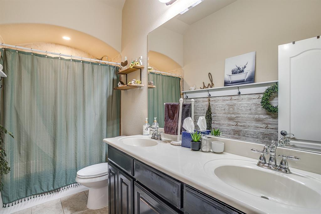 9409 County Road 915 Godley, TX 76044 - Photo 24 of 40 a bathroom with double sink and a mirror