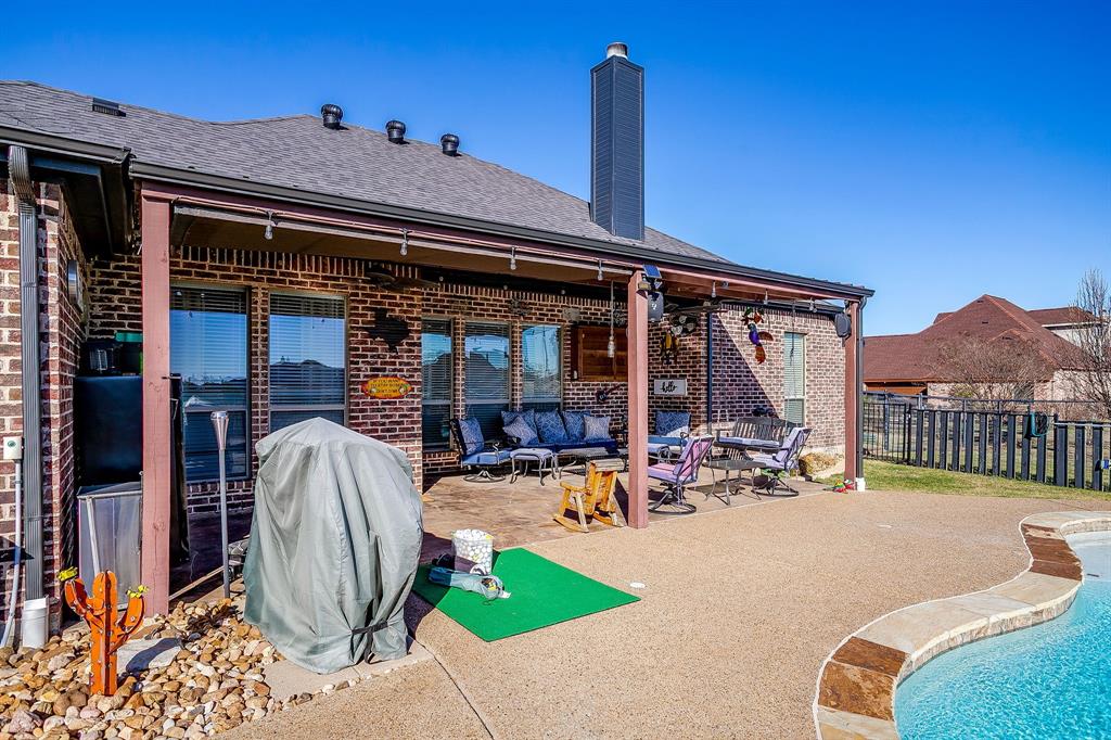 9409 County Road 915 Godley, TX 76044 - Photo 30 of 40 a view of a patio with a table and chairs