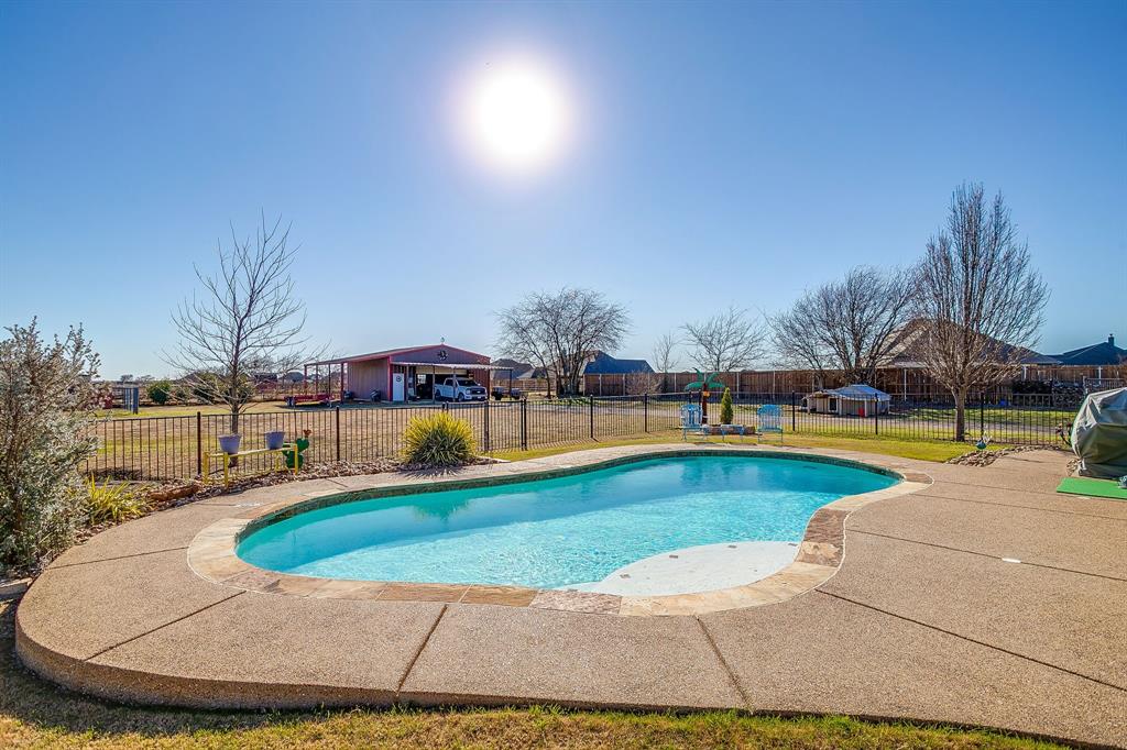 9409 County Road 915 Godley, TX 76044 - Photo 37 of 40 a view of a swimming pool with an outdoor seating