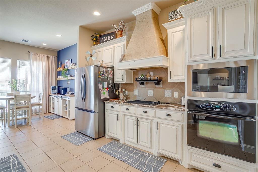 9409 County Road 915 Godley, TX 76044 - Photo 5 of 40 a kitchen with a stove and a refrigerator
