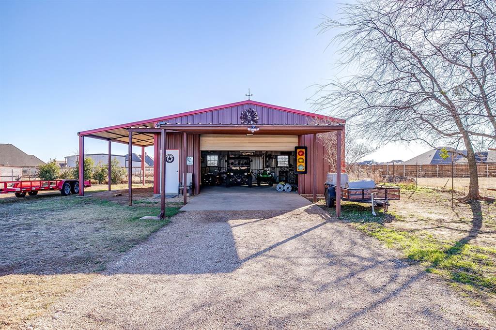 9409 County Road 915 Godley, TX 76044 - Photo 6 of 40 a front view of a house with a yard and trees
