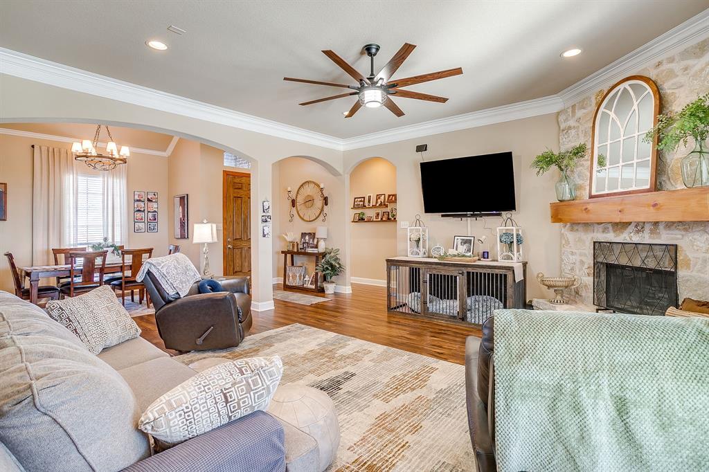 9409 County Road 915 Godley, TX 76044 - Photo 10 of 40 a living room with furniture a fireplace and a flat screen tv