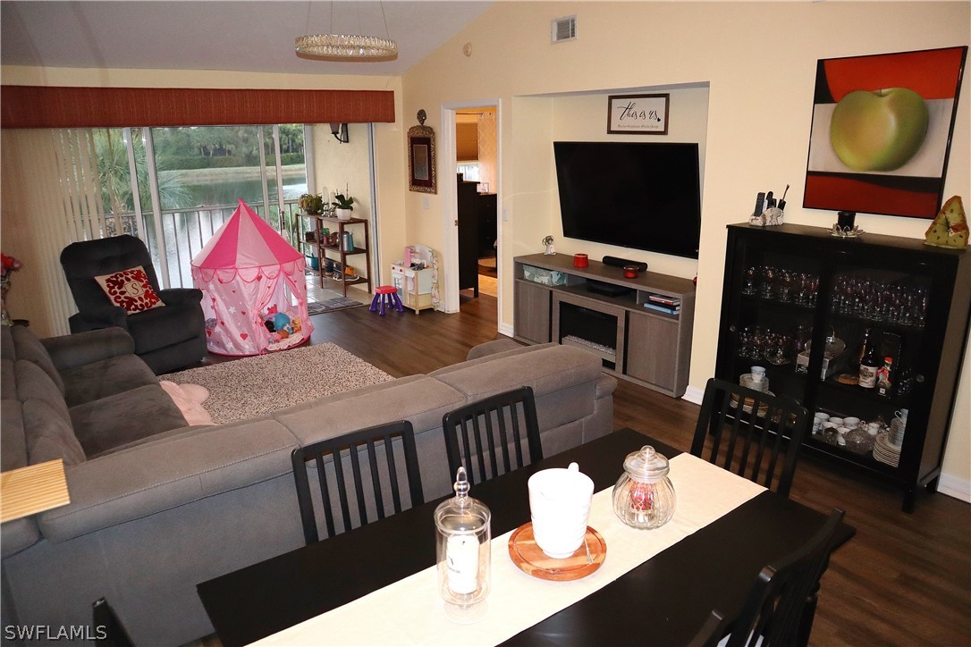 121 Gabriel Circle, Unit 10 Naples, FL 34104 - Photo 11 of 25 a living room with furniture and a flat screen tv