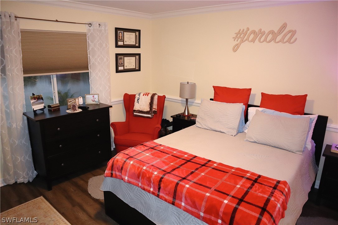 121 Gabriel Circle, Unit 10 Naples, FL 34104 - Photo 12 of 25 a bedroom with a bed and a dresser