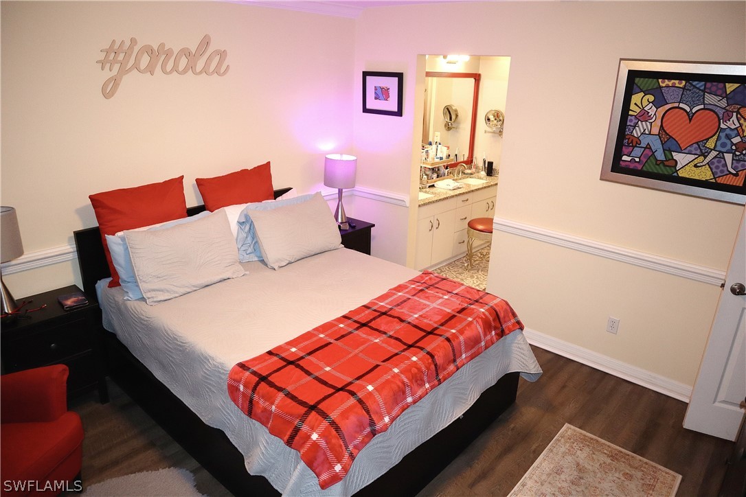 121 Gabriel Circle, Unit 10 Naples, FL 34104 - Photo 13 of 25 a bed sitting in a bedroom next to a window