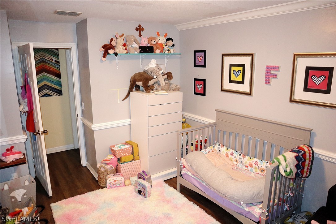 121 Gabriel Circle, Unit 10 Naples, FL 34104 - Photo 18 of 25 a bedroom with a bed and a white furniture