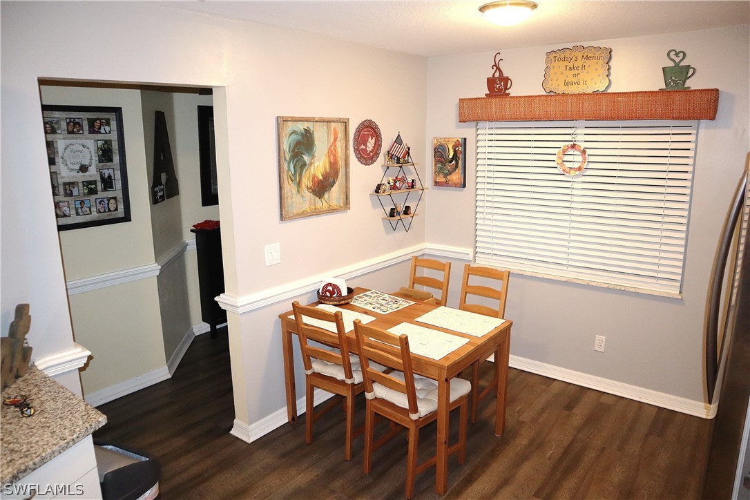 121 Gabriel Circle, Unit 10 Naples, FL 34104 - Photo 4 of 25 a view of a room with furniture and wooden floor