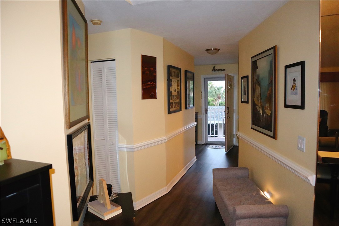 121 Gabriel Circle, Unit 10 Naples, FL 34104 - Photo 7 of 25 a hallway with wooden floor and furniture