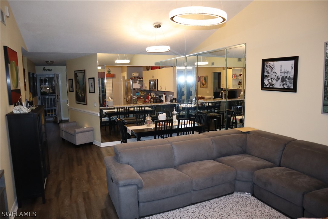 121 Gabriel Circle, Unit 10 Naples, FL 34104 - Photo 9 of 25 a living room with furniture and wooden floor