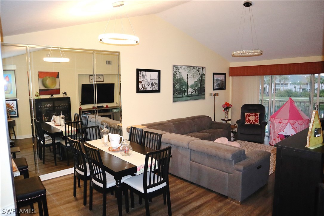 121 Gabriel Circle, Unit 10 Naples, FL 34104 - Photo 10 of 25 a living room with furniture a flat screen tv and a fireplace