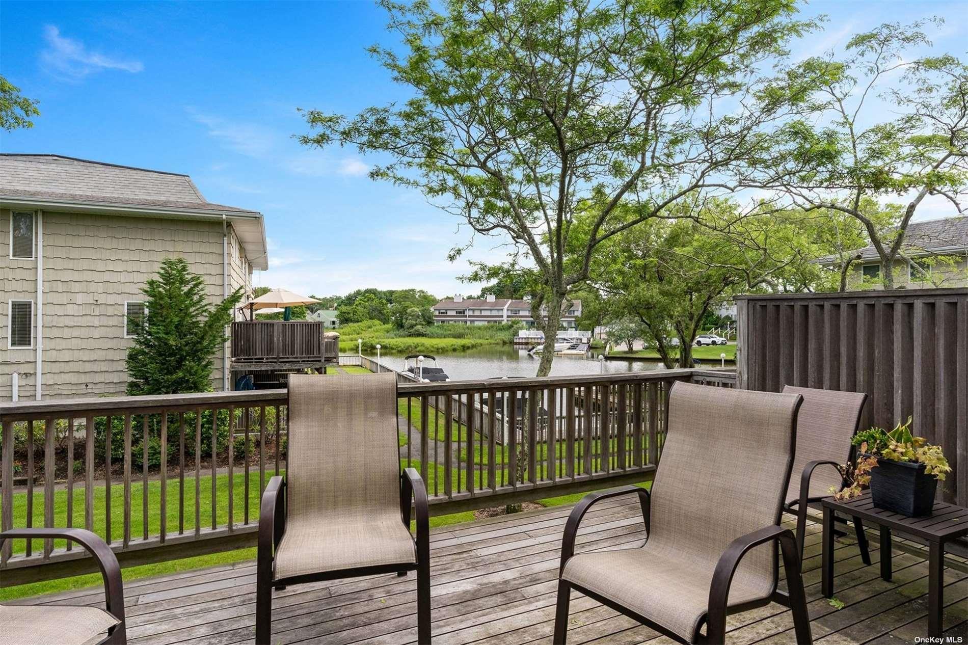 3029 Mitchell Road Westhampton Beach, NY 11978 - Photo 4 of 12 a view of a chair and table on the wooden floor