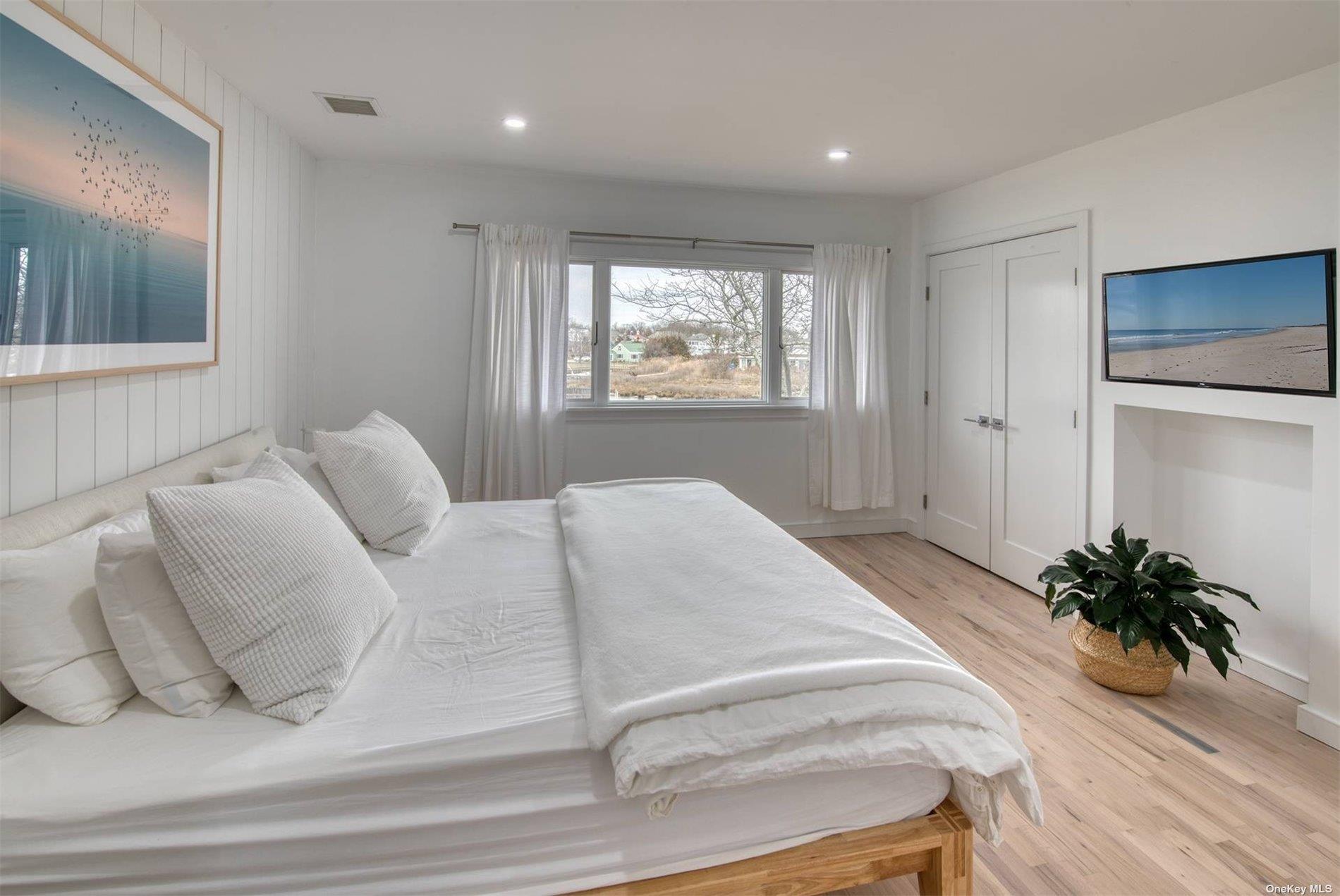 3029 Mitchell Road Westhampton Beach, NY 11978 - Photo 5 of 12 a bedroom with a bed and a window