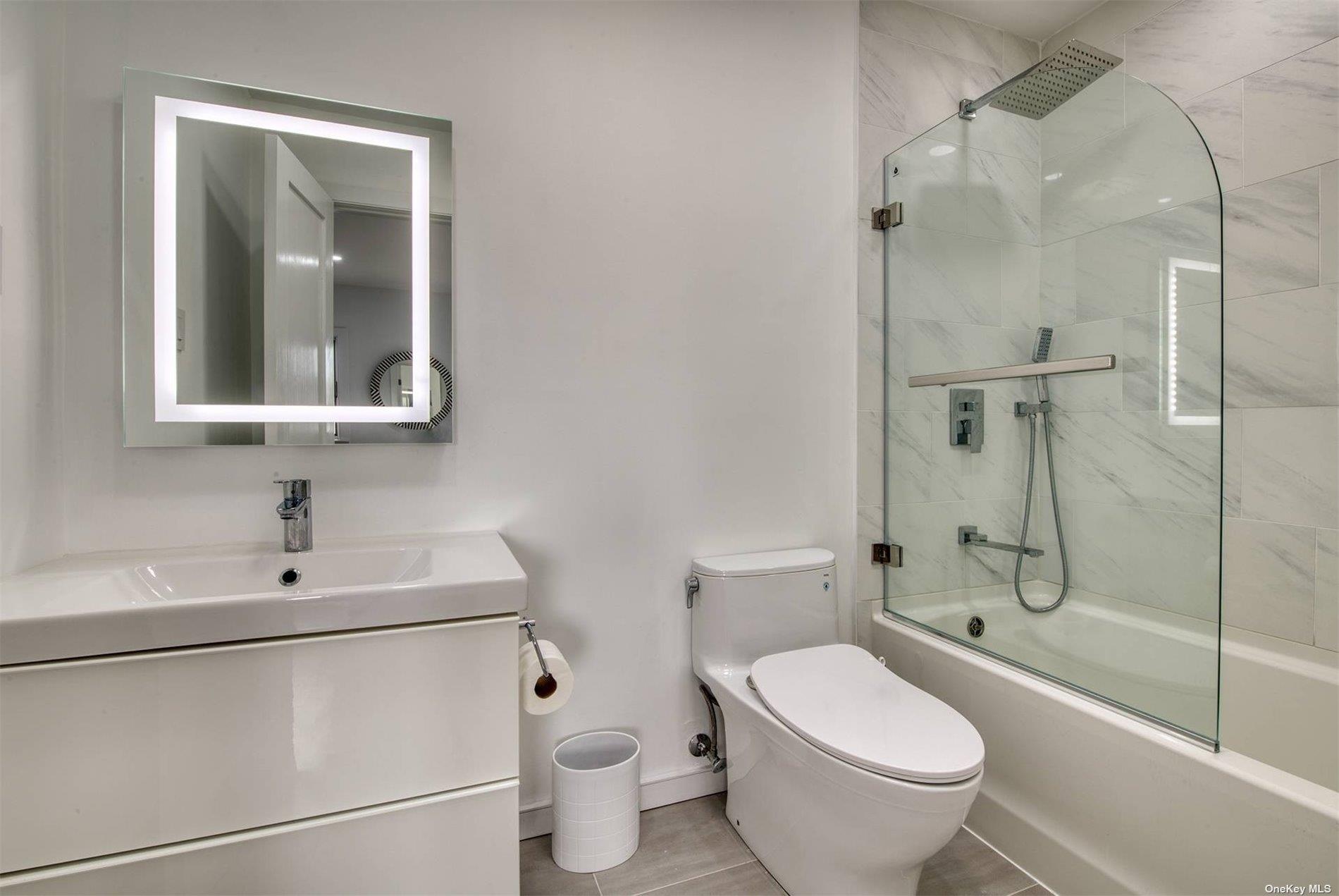 3029 Mitchell Road Westhampton Beach, NY 11978 - Photo 8 of 12 a bathroom with a toilet sink and shower