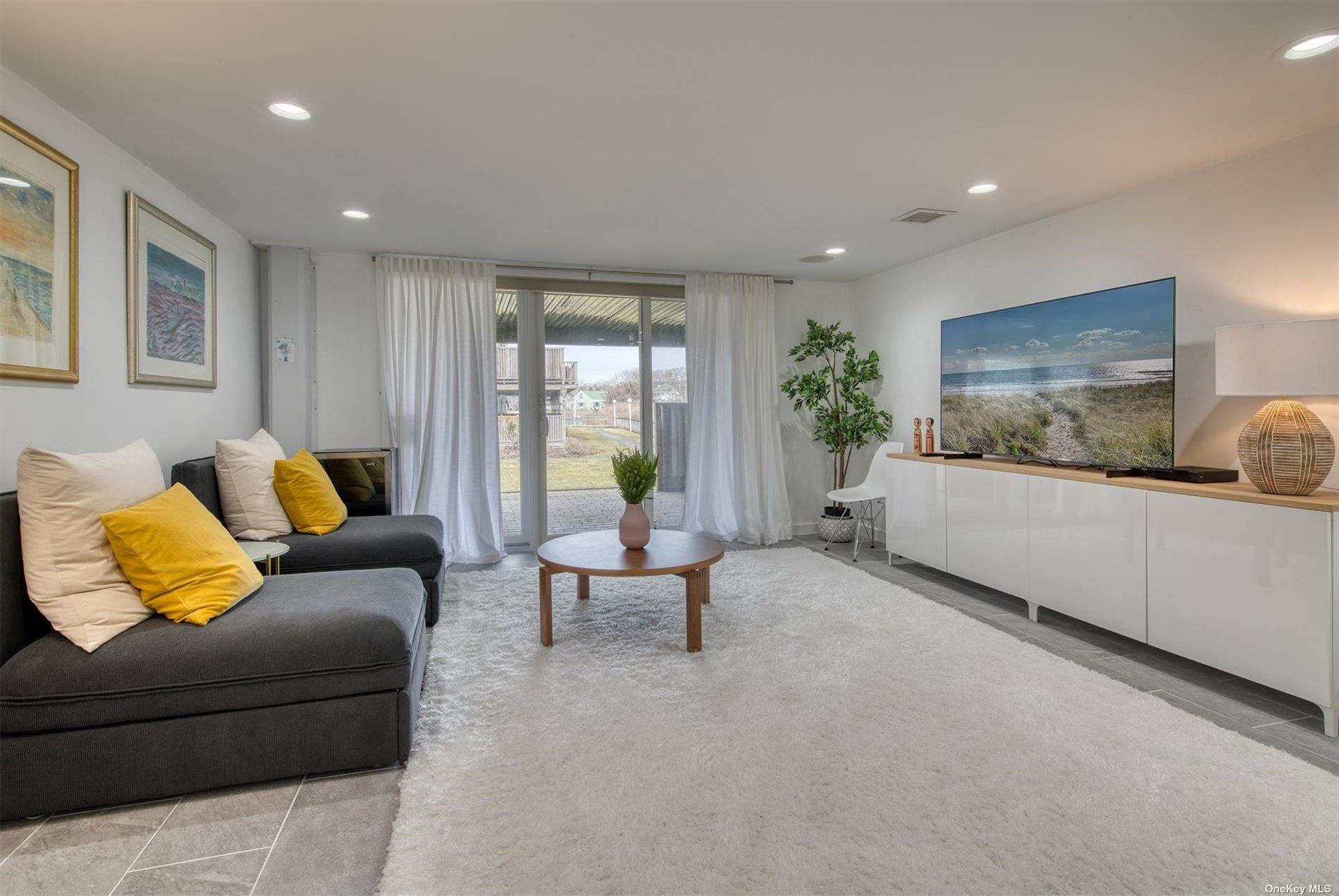 3029 Mitchell Road Westhampton Beach, NY 11978 - Photo 9 of 12 a living room with furniture and a couch