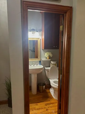 a bathroom with a sink a toilet and mirror
