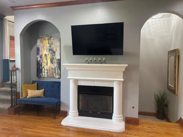 a living room with furniture a flat screen tv and a fireplace